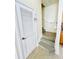 Staircase and laundry closet with wood-look tile flooring at 2280 San Vital Dr # 105, Kissimmee, FL 34741