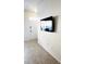 Bright entryway with wood-look tile flooring and a mounted television at 2280 San Vital Dr # 105, Kissimmee, FL 34741