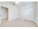 Simple bedroom with neutral walls, carpet flooring, and double doors to closet at 7127 Harmony Square S Dr # 7127, Harmony, FL 34773