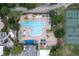 Community pool, tennis courts, and parking are visible in this aerial view at 7127 Harmony Square S Dr # 7127, Harmony, FL 34773