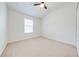 Bright bedroom featuring neutral carpeting and a ceiling fan at 7127 Harmony Square S Dr # 7127, Harmony, FL 34773