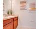 Clean bathroom with wood cabinets and a large mirror at 7127 Harmony Square S Dr # 7127, Harmony, FL 34773