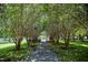 Shaded walkway with lush landscaping, creating a serene path at 7127 Harmony Square S Dr # 7127, Harmony, FL 34773