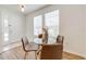 Bright dining area with glass table and four brown chairs at 7127 Harmony Square S Dr # 7127, Harmony, FL 34773