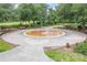 Circular water feature is the centerpiece of this community park, surrounded by benches and lush landscaping at 7127 Harmony Square S Dr # 7127, Harmony, FL 34773