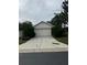 House exterior with a two-car garage and driveway at 2796 Whispering Trails Dr, Winter Haven, FL 33884