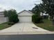 House exterior with a two-car garage and driveway at 2796 Whispering Trails Dr, Winter Haven, FL 33884