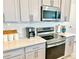 Modern kitchen with stainless steel appliances and white countertops at 742 Longboat Dr, Davenport, FL 33896
