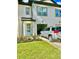 Townhome with light teal and white exterior, attached garage, and landscaping at 742 Longboat Dr, Davenport, FL 33896