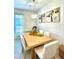 Bright dining room with light wood table and six white chairs at 742 Longboat Dr, Davenport, FL 33896