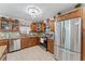 Well-equipped kitchen with stainless steel appliances and wood cabinets at 1395 Emerald Dr, Kissimmee, FL 34744