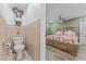 Small toilet and sink area with beige tile at 1395 Emerald Dr, Kissimmee, FL 34744