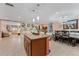 Open concept kitchen with island and views to the living and dining areas at 1395 Emerald Dr, Kissimmee, FL 34744
