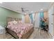 King-size bedroom with floral bedding, ceiling fan, and built-in wardrobe at 1395 Emerald Dr, Kissimmee, FL 34744