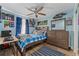 Blue and white bedroom with a double bed, dresser, and ceiling fan at 1395 Emerald Dr, Kissimmee, FL 34744