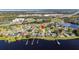 House on a lakefront property with a large yard and surrounding houses at 1395 Emerald Dr, Kissimmee, FL 34744