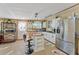 Bright kitchen with white cabinets, stainless steel appliances, and an island at 1395 Emerald Dr, Kissimmee, FL 34744