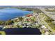 House on a lakefront property with a large yard and surrounding houses at 1395 Emerald Dr, Kissimmee, FL 34744