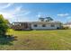 House exterior and backyard with grassy lawn at 1395 Emerald Dr, Kissimmee, FL 34744