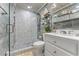 Modern bathroom with a large walk-in shower, double vanity, and marble tile at 1395 Emerald Dr, Kissimmee, FL 34744