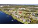 House on a lakefront property with a large yard and surrounding houses at 1395 Emerald Dr, Kissimmee, FL 34744
