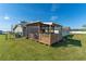 Home exterior showcasing a screened patio and yard at 1395 Emerald Dr, Kissimmee, FL 34744