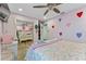 Bedroom with a double bed, mirrored closet doors, and pink accents at 1395 Emerald Dr, Kissimmee, FL 34744