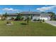 Cute ranch home with a well-maintained lawn and a two-car garage at 1395 Emerald Dr, Kissimmee, FL 34744