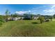 Ranch style home with a well-manicured lawn and tropical landscaping at 1395 Emerald Dr, Kissimmee, FL 34744