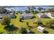 Aerial view of a single-Gathering home with a large backyard, lakefront access, and detached shed at 1395 Emerald Dr, Kissimmee, FL 34744