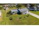 Single-story house with a large backyard, and several surrounding houses at 1395 Emerald Dr, Kissimmee, FL 34744