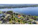 House on a lakefront property with a large yard and surrounding houses at 1395 Emerald Dr, Kissimmee, FL 34744