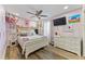 Cute bedroom with a double bed, white dresser, and pink accents at 1395 Emerald Dr, Kissimmee, FL 34744