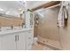 Clean bathroom with a walk-in shower, white vanity, and ample storage at 1395 Emerald Dr, Kissimmee, FL 34744