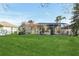 Large backyard with screened pool and lush green grass at 805 Via Bianca Dr, Davenport, FL 33896