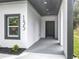 Covered entryway with dark gray door and white walls at 135 S Chandler Ave, Deland, FL 32724