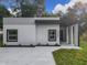 Modern house exterior with gray accents and a covered entryway at 135 S Chandler Ave, Deland, FL 32724