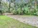Large backyard with cleared and grassy areas at 135 S Chandler Ave, Deland, FL 32724