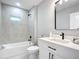 Modern bathroom with grey tile and white vanity at 135 S Chandler Ave, Deland, FL 32724