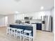 Modern kitchen with white quartz island, blue cabinets, and stainless steel appliances at 135 S Chandler Ave, Deland, FL 32724