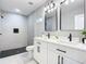 Modern bathroom with double vanity and walk-in shower at 135 S Chandler Ave, Deland, FL 32724