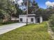 Modern house exterior with gray siding, a driveway, and a grassy lawn at 135 S Chandler Ave, Deland, FL 32724