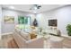 Living room featuring white sofa, gold accents, and a large TV at 135 S Chandler Ave, Deland, FL 32724