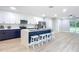 Open concept kitchen with island seating, stainless steel appliances, and two-toned cabinets at 135 S Chandler Ave, Deland, FL 32724