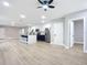 Open concept living area with kitchen island and hardwood floors at 135 S Chandler Ave, Deland, FL 32724