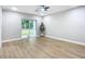 Bright living room with sliding glass doors and light gray walls at 135 S Chandler Ave, Deland, FL 32724