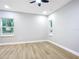 Bright bedroom with wood-look floors and large windows at 135 S Chandler Ave, Deland, FL 32724