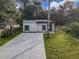 Aerial view of a modern house with a concrete driveway at 135 S Chandler Ave, Deland, FL 32724