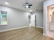 Bedroom with ceiling fan and access to bathroom at 135 S Chandler Ave, Deland, FL 32724