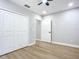 Bedroom with hardwood floors and double door closet and door to another room at 135 S Chandler Ave, Deland, FL 32724